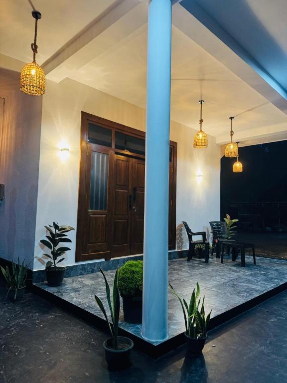 a house with a porch with potted plants and lights at Villa Calista Weligama in Weligama