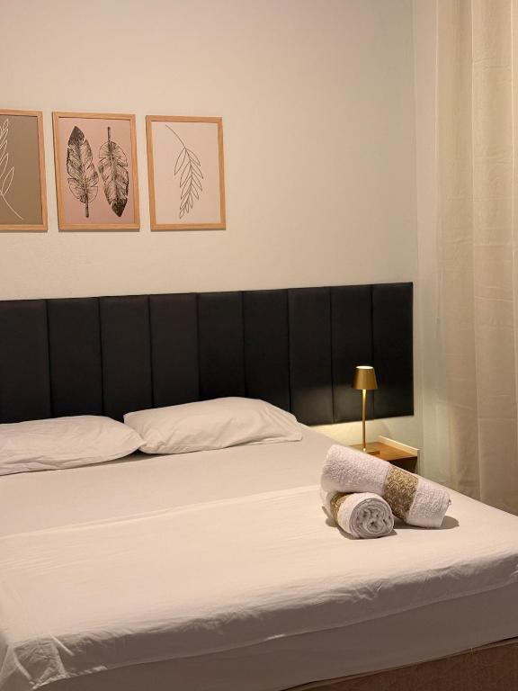a bedroom with a bed with a towel on it at Studio completo em Diamantina-MG in Diamantina