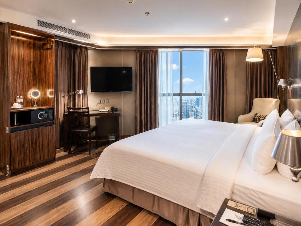 a hotel room with a large bed and a desk at Hotel Relax I in Taipei