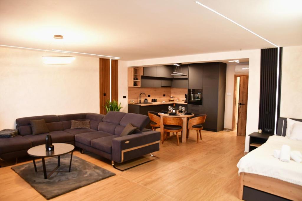 a living room with a couch and a table at Politon Suites in Zaječar