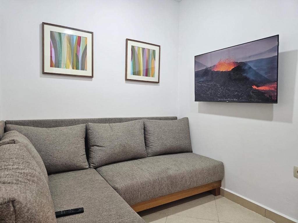 a living room with a couch and two pictures on the wall at Le Diamant in Tétouan