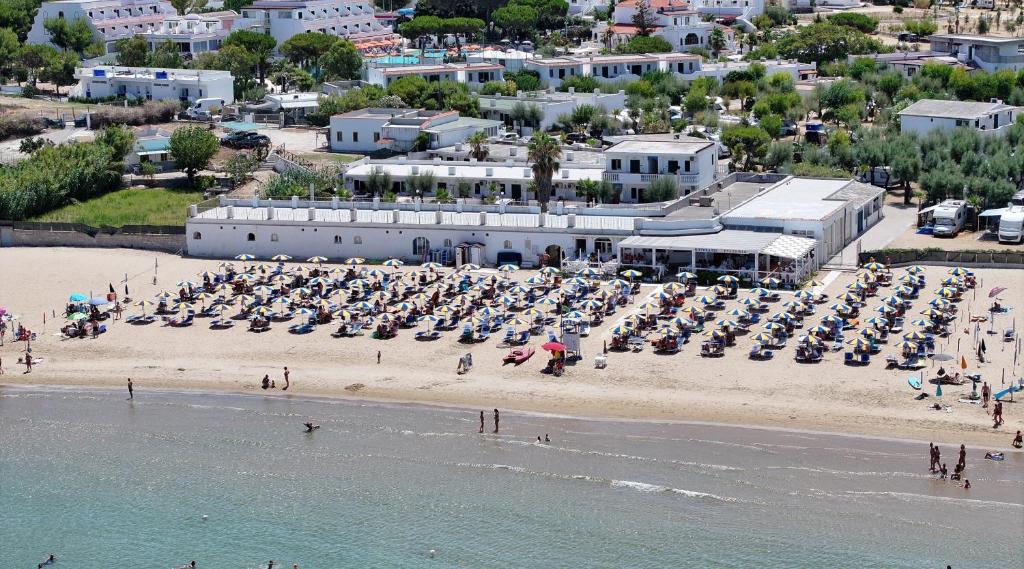 an aerial view of a beach with a bunch of chairs at Villaggio Bellariva in Peschici