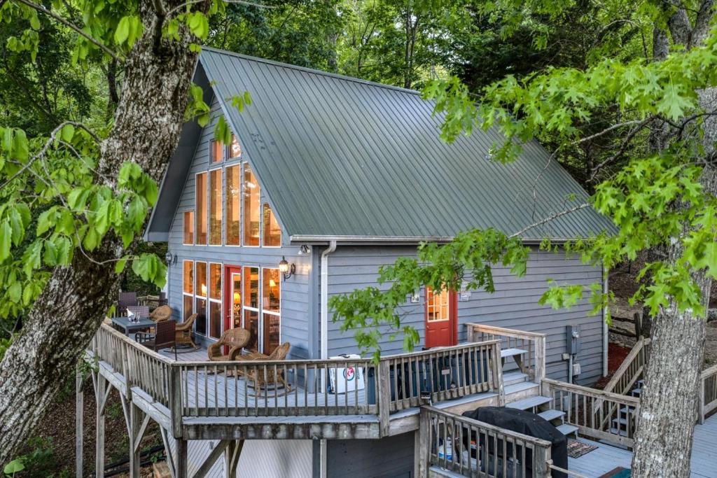 a house with a porch and a tree at Spectacular Mountain View - Cloud 9 - HotTub-PETS OK in Cleveland