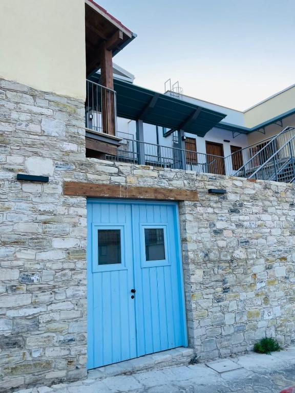 a blue garage door on a stone building at Kalavasos Xenia in Kalavasos