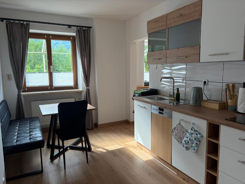 a small kitchen with a table and a dining room at Patrycja 2 Top 1 in Ehenbichl