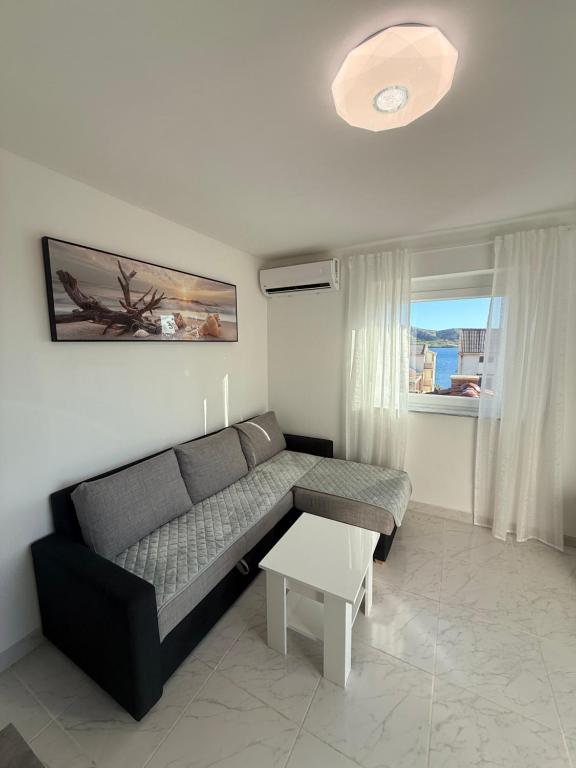 a living room with a couch and a table at Apartmani Lucija 3 in Zubovići