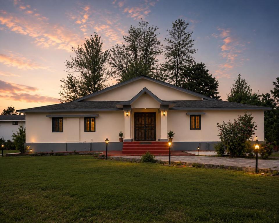 a white house with a lawn in front of it at Doi Stays Dak Bungalow in Almora