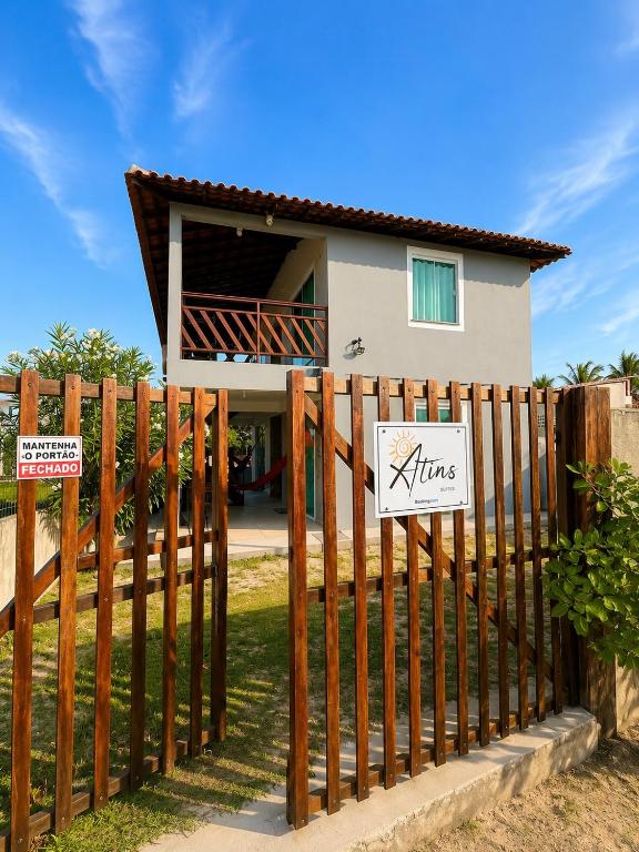 a wooden fence in front of a house at Atins Suites in Atins