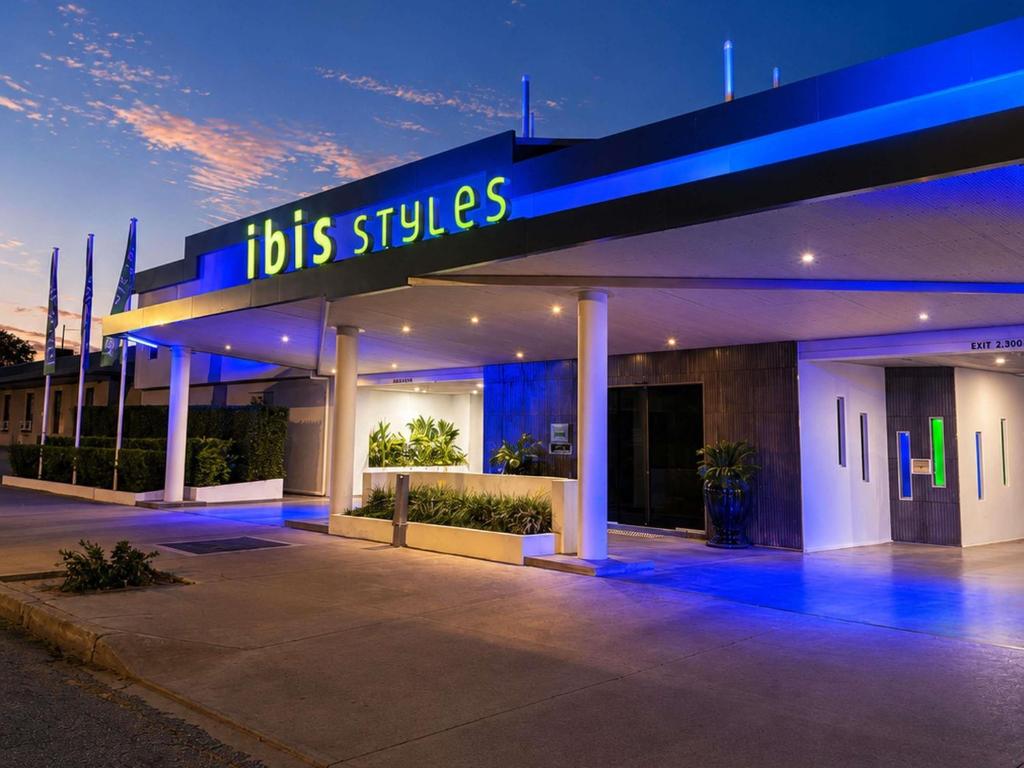 a building with a blue lit sign in front of it at ibis Styles Broken Hill in Broken Hill