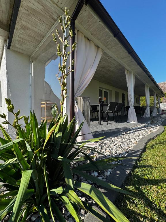 a covered patio with a table and chairs at Domek pod Jabłonią in Barzowice