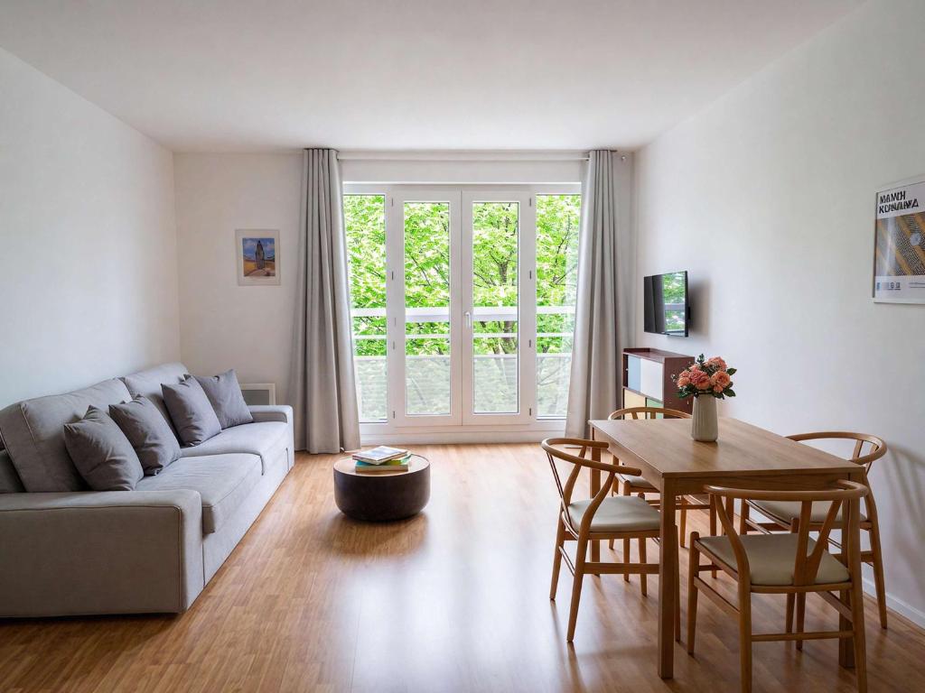 a living room with a couch and a table at Paris Bercy with car park by Melvane in Charenton-le-Pont