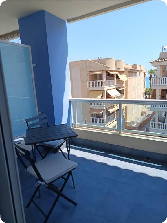 a table and chair on a balcony with a view at Piso Delfin Playa in Moncófar
