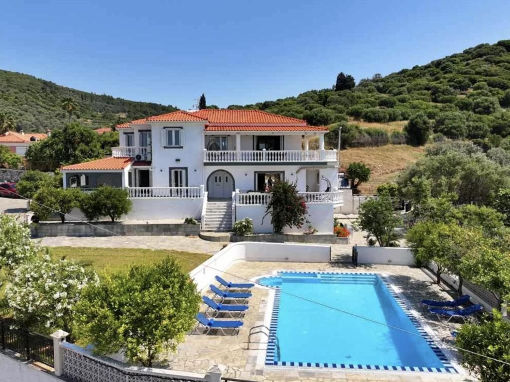 an image of a house with a swimming pool at Villa Karras in Pythagoreio