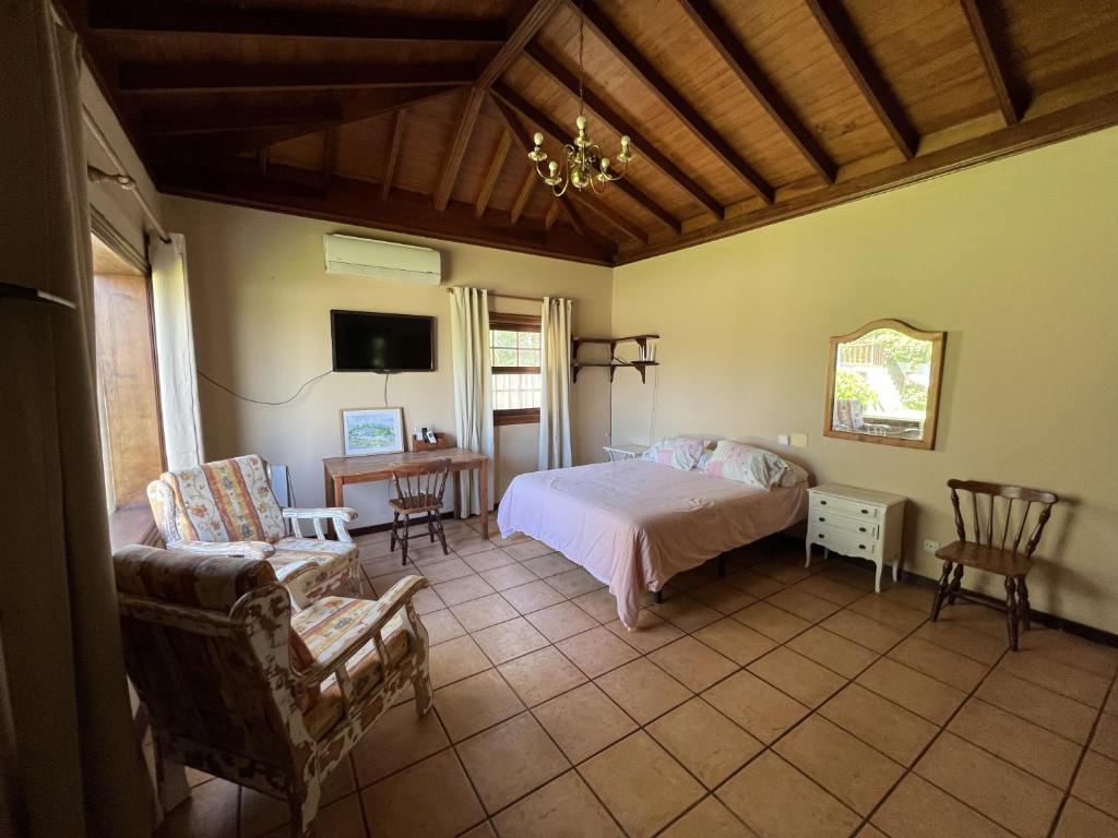 a bedroom with a bed and a table and chairs at La Huerta in Tacoronte