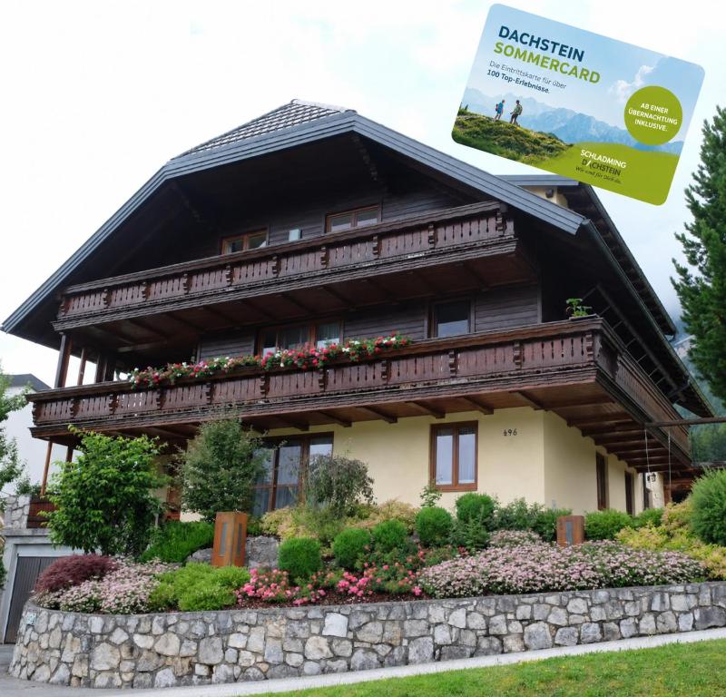 a house with a sign in front of it at Putz Appartements in Gröbming