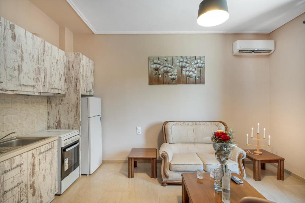 a kitchen and living room with a couch and a table at Magician's Apartments in Lefkada