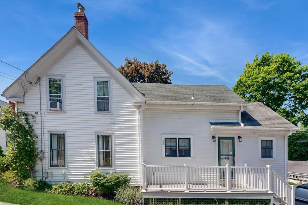 an old white house with a porch at Beautiful Retreat | Home Office | Walk 5 MInutes to Main Street in Wiscasset