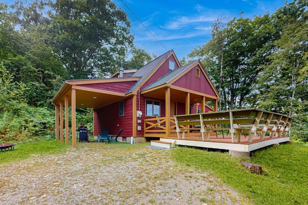 a small red house with a large porch at Beautiful hilltop home with deck & view of Penobscot Bay - near festivals & more in Rockport