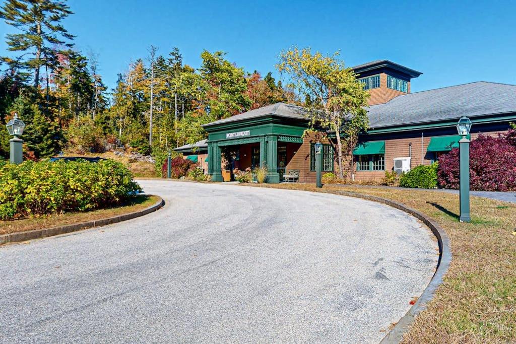 a house with a road in front of a building at Comfortable two bedroom cabin with firepit, kitchen, hiking trail within walking in Northport