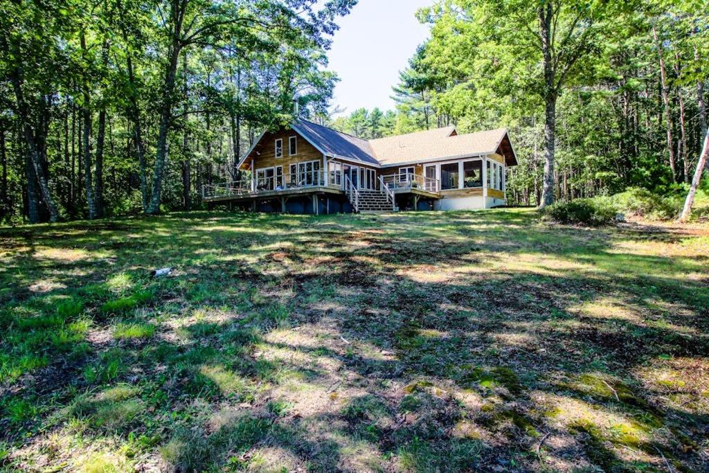 a large house in the middle of a yard at Private waterfront home with large deck & deep water dock in Georgetown