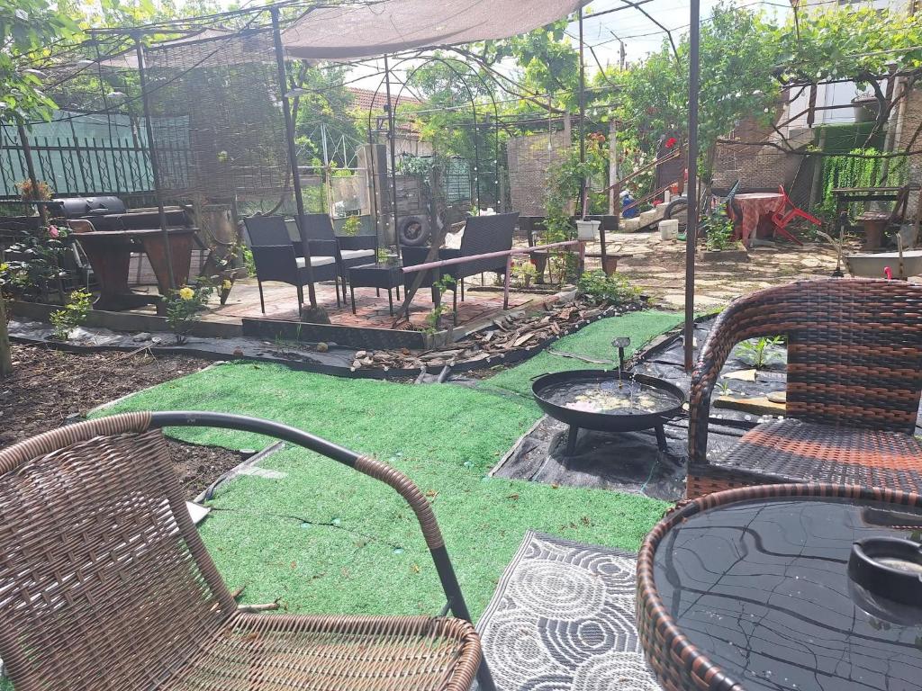 a patio with chairs and a table with grass at Cactus house in Ovchartsi
