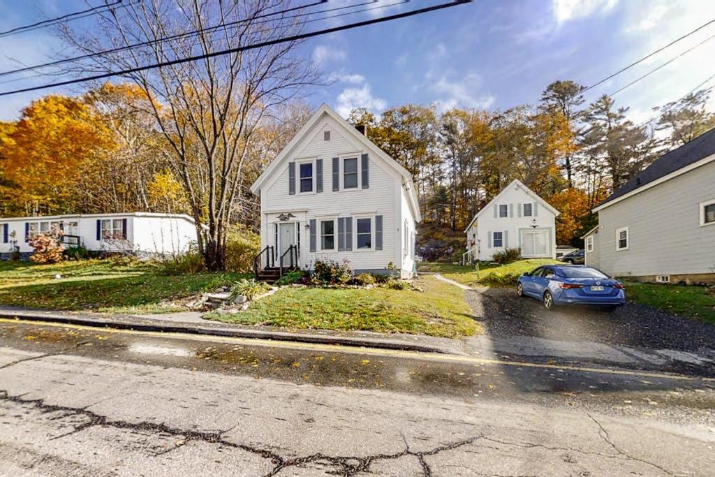 a white house with a car parked in the street at Coastal home with new, full kitchen, walkable downtown location in Boothbay Harbor