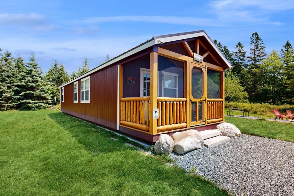 a large wooden cabin with a large window at Cozy Cabin with Ocean and Mountain Views, Free Internet in Sullivan