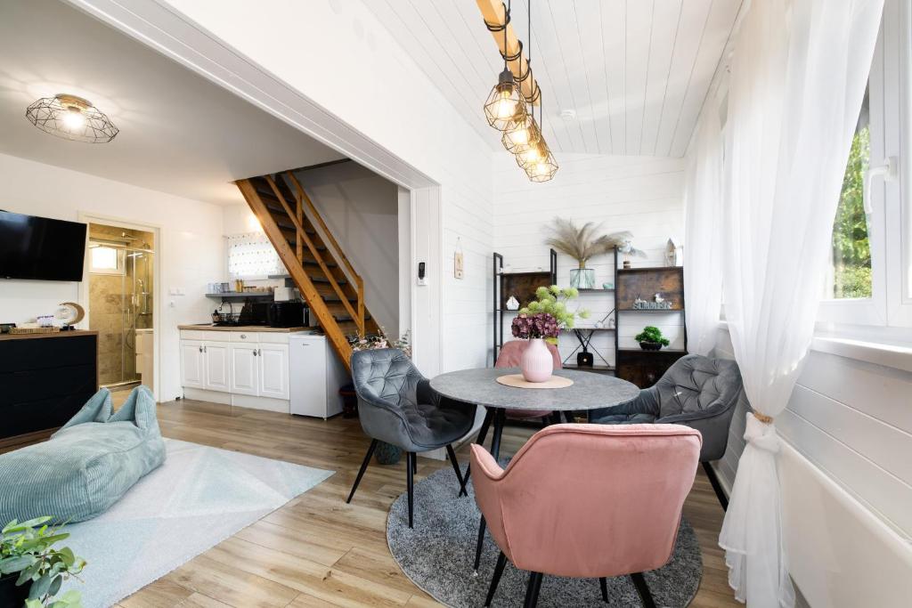 a kitchen and living room with a table and chairs at Fövenyes Hideaway in Balatonudvari