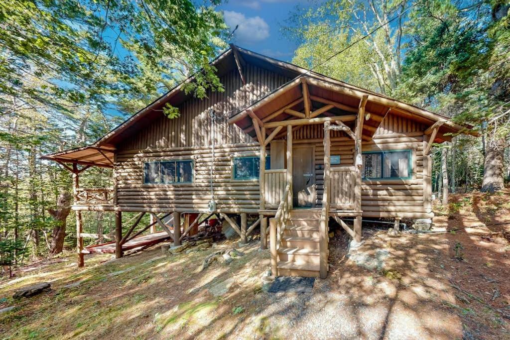 a log cabin in the woods with trees at Stunning log cabin with fireplace & nature views - near shopping & dining in Boothbay Harbor