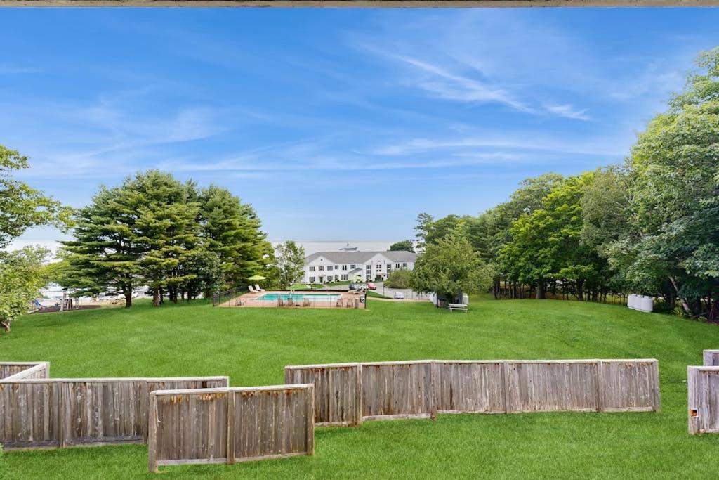 a yard with a fence and a skate park at Newly-furnished condo with loft, fast WiFi, partial AC, grills & yard access in Bar Harbor