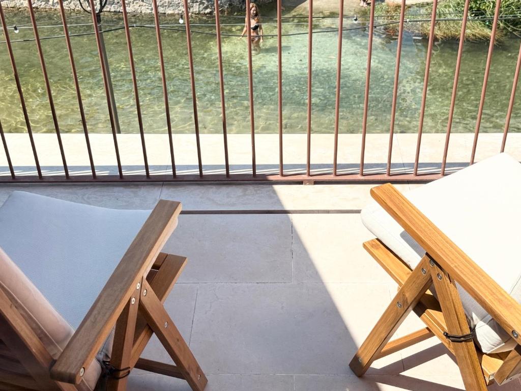 two chairs and a table on a balcony at Grota Lodging in Leiria