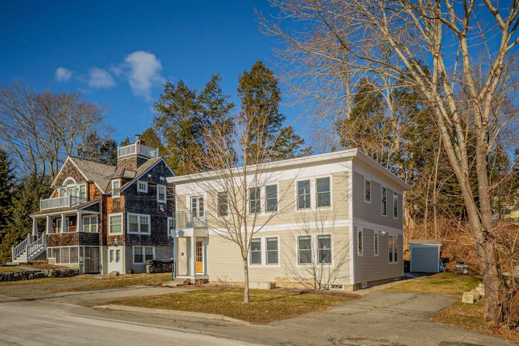 a large white house with a black at Waterfront, walkable, updated home with harbor views & partial AC in Camden