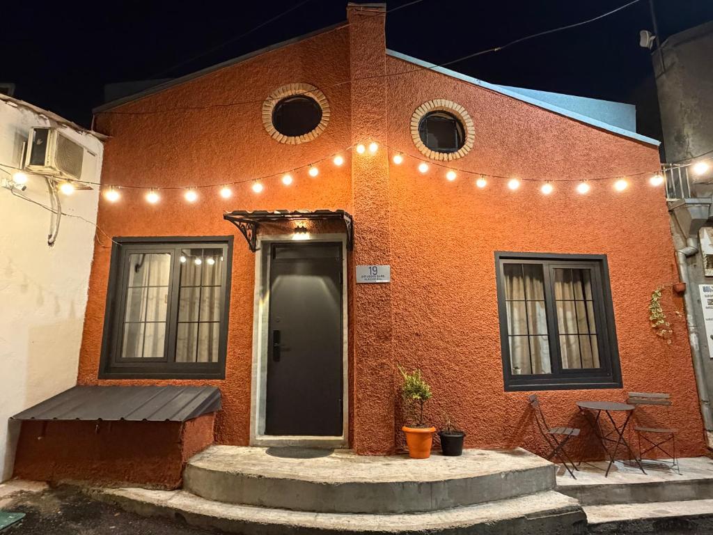 a brick house with lights on the side of it at Duplex Hause in Telavi