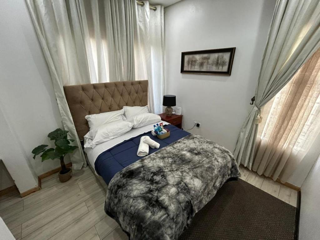 a bedroom with a bed with two stuffed animals on it at Serenity Haven in Chongwe