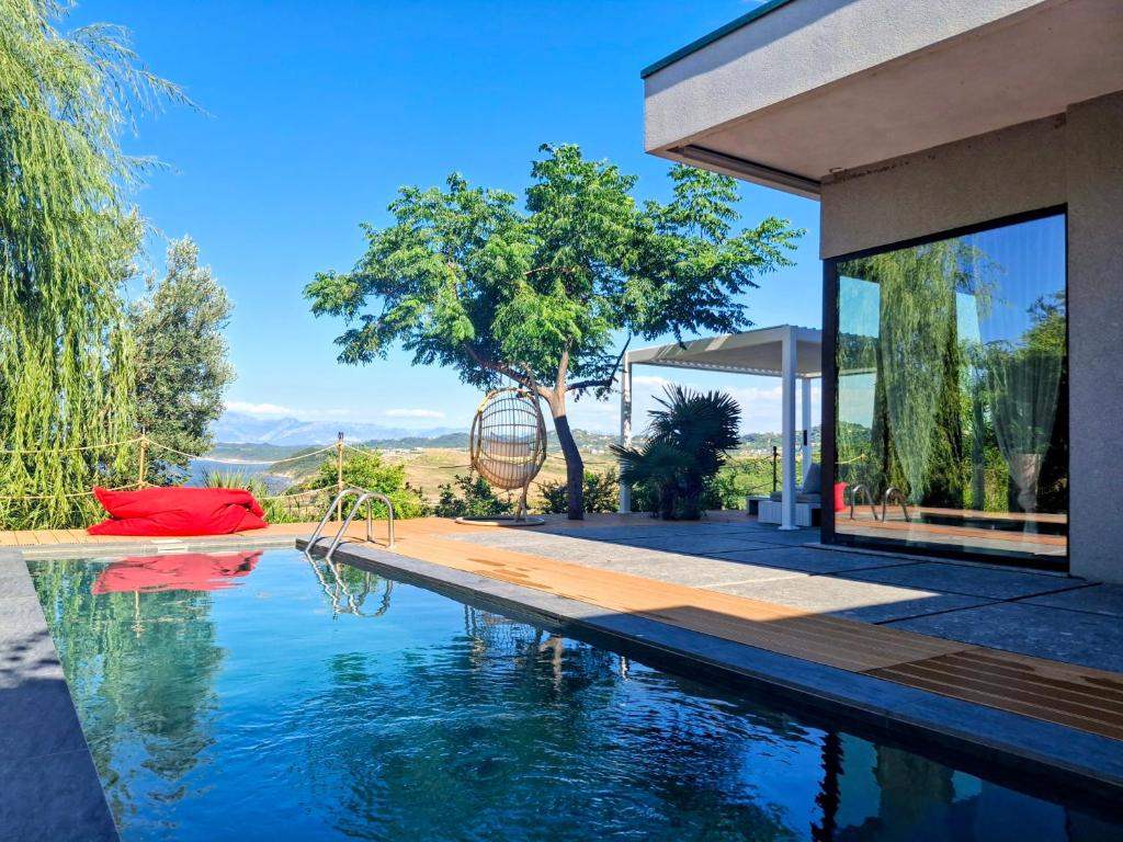 a house with a swimming pool with a view at Rezidenca - Villa Cape Of Rodon in Draç