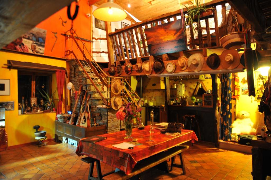 a room with a table and a staircase with pots and pans at Chambre d'hôtes Erziwezh in Sainte-Marie