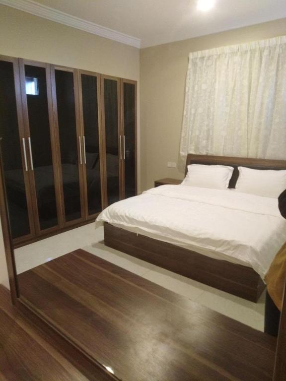 a bedroom with a large bed and a window at فلل و شقق سحاب أبها in Abha