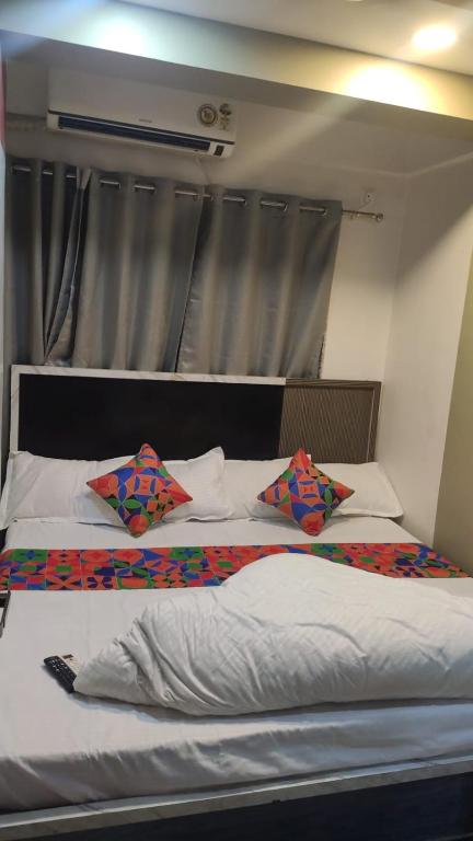 two beds in a room with two pillows on them at Hotel SR Imperial in Kolkata