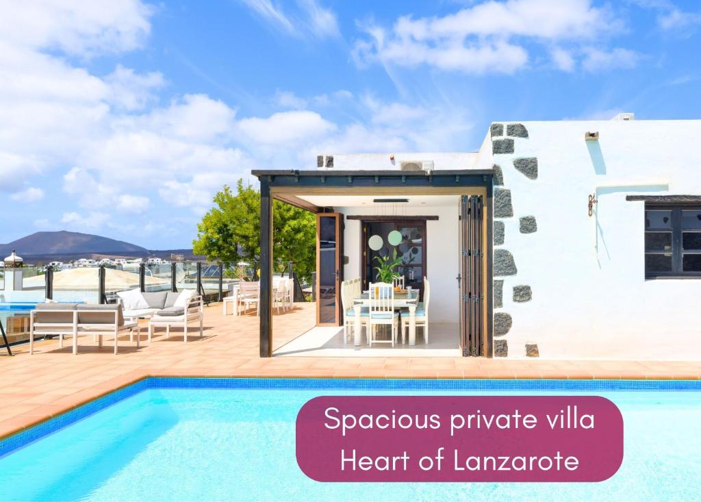 a villa with a swimming pool in a resort at Spacious Private Villa up to 16 - Casa Quintero Yaiza - Volcano, Timanfaya park, Bodega & South Beaches - Heated Pool - Game Room - Charcoal grill in Yaiza