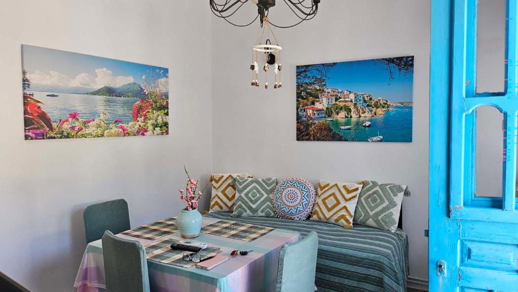 a living room with a table and a couch at Comfort and unparalleled view in Kóronos