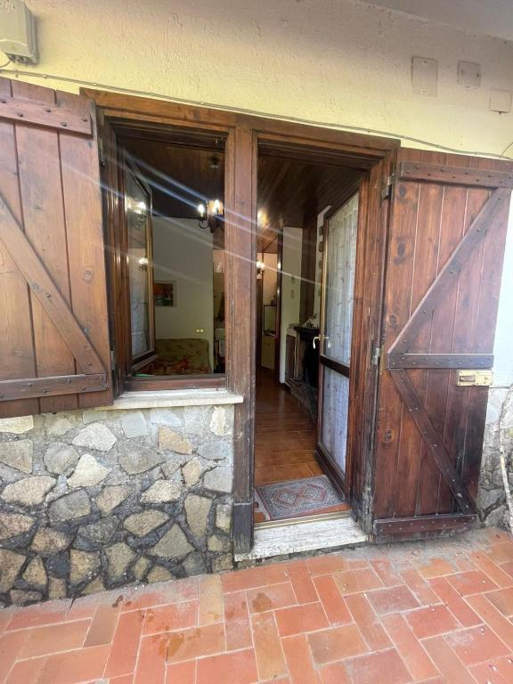 an entrance to a house with wooden doors at Montanara Home in Camigliatello Silano