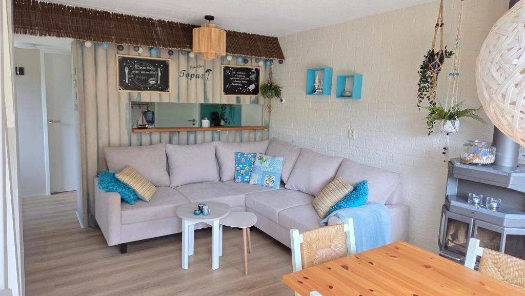 a living room with a couch and a table at Vakantiehuis Topaz in Bruinisse