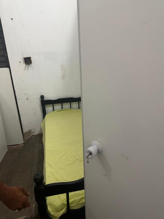 a door to a room with a bed in it at Dormitório in Uberlândia