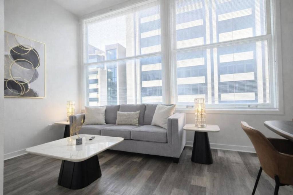 a living room with a couch and a large window at Urban Escape in Indianapolis