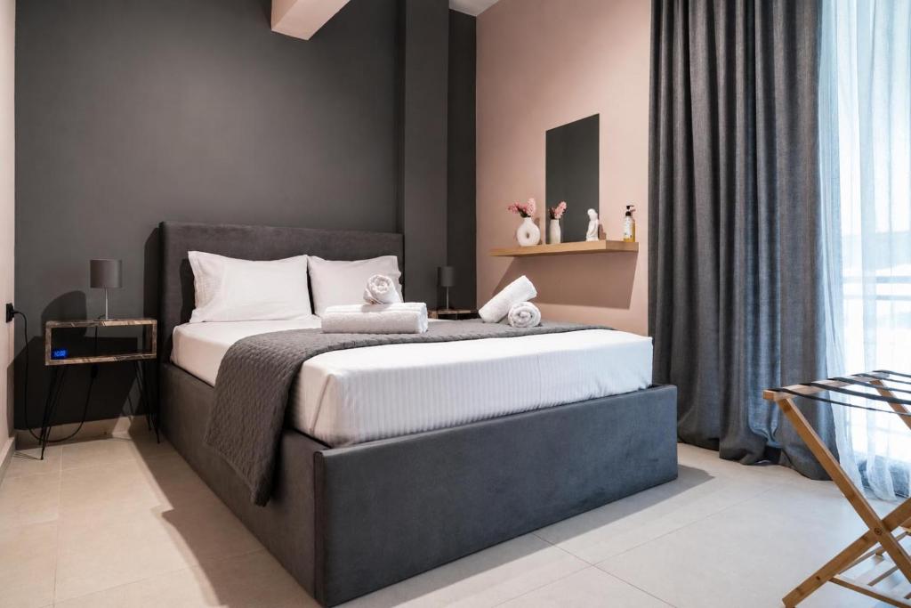 a bedroom with a large bed in a room at Swan Paradise Tolo in Tolo