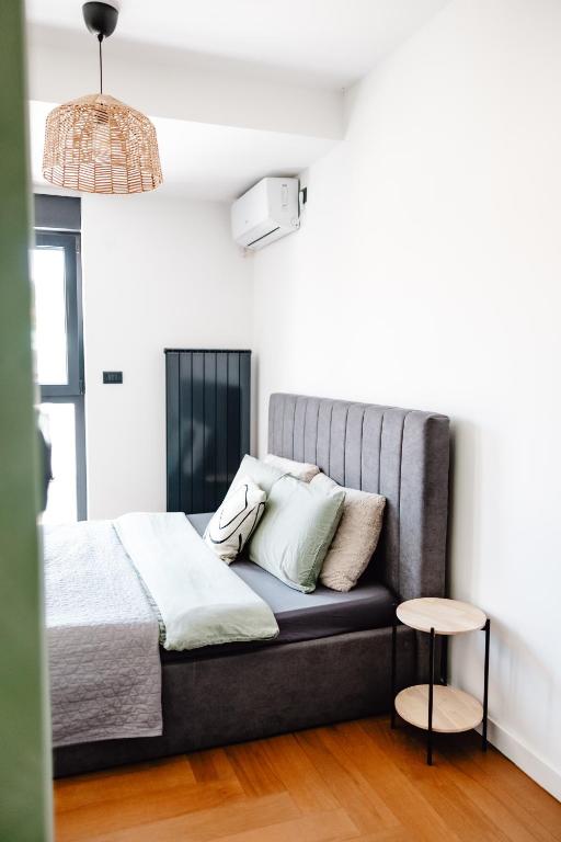 a bedroom with a bed and a table at Zs Apartment in Tuzla