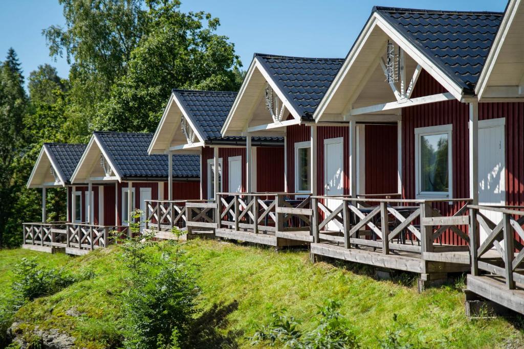 a row of red cottages at a resort at Visitor Stugby in Håverud