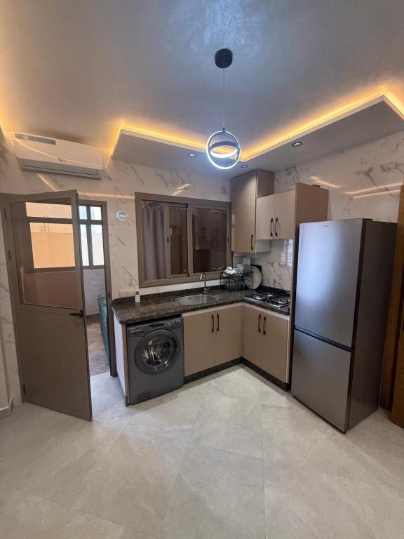 a kitchen with a refrigerator and a dishwasher at اقامة هبة 6 in Yebha