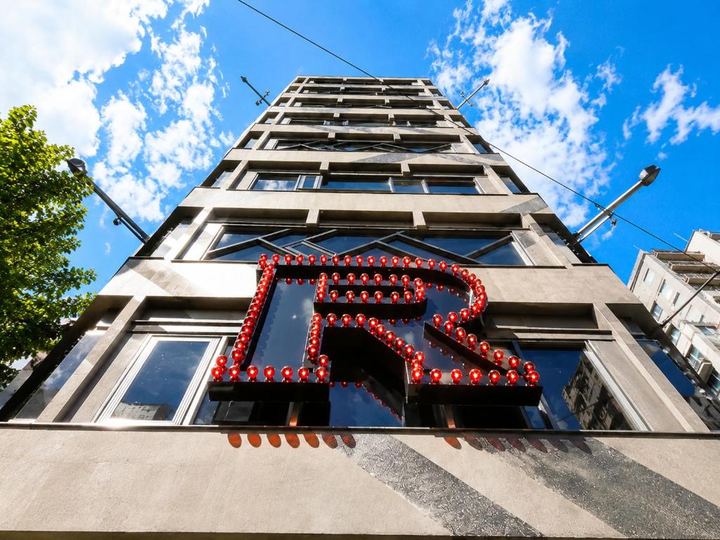 a tall building with a x sign on it at Hotel Relax 5 in Taipei