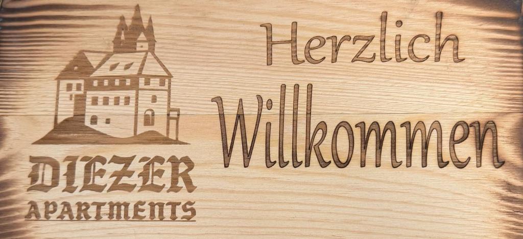 a wooden sign with a drawing of a building on it at Diezer Apartments II City in Diez